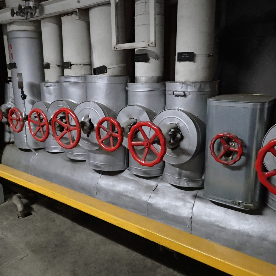 Picture of a steam distribution system showing steam pipes and valves